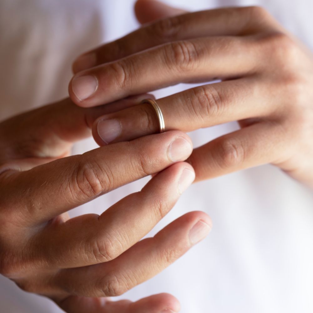 woman taking off ring because of divorce